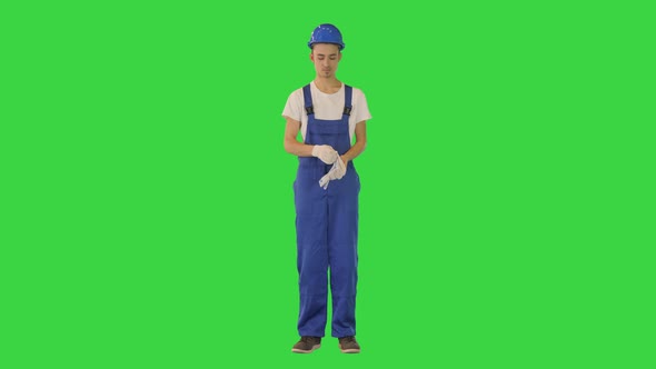 Construction Worker Wearing Protective Gloves on a Green Screen Chroma Key alt