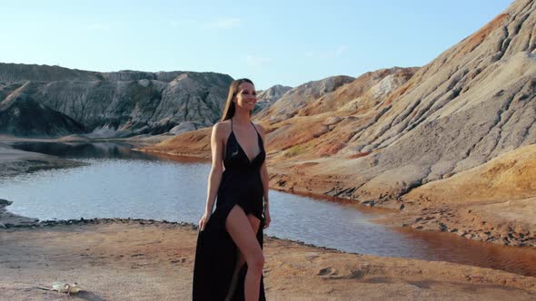 Beautiful woman posing on other-worldly hilly landscape