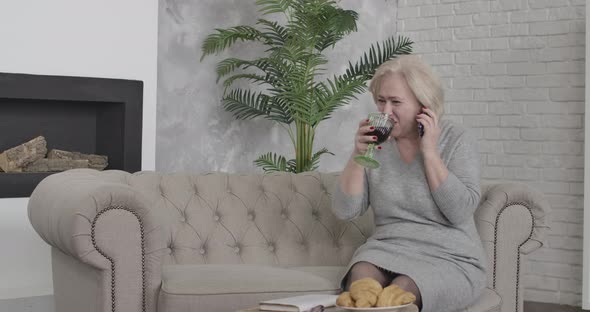 Portrait of Joyful Middle-aged Caucasian Woman Laughing and Talking on the Phone. Confident Happy alt