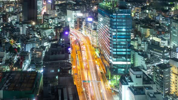 Time Lapse of busy highway and the buildings of Tokyo Japan at night alt