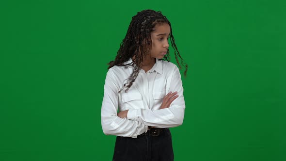 Portrait of Teen African American Girl Looking Around Crossing Hands and Looking at Camera with Sad alt