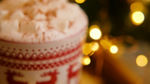 Close-up of a Christmas mug of coffee with marshmallows with cinnamon