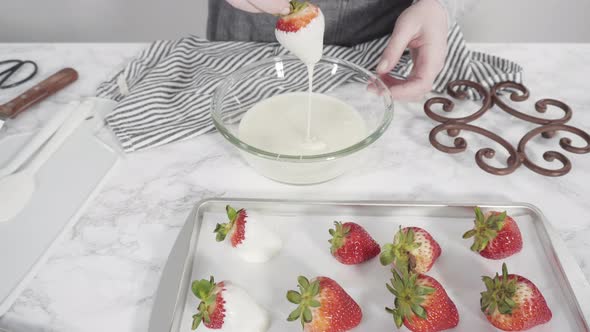 Step by step. Dipping organic strawberries into a bowl with melted chocolate to prepare chocolate co alt