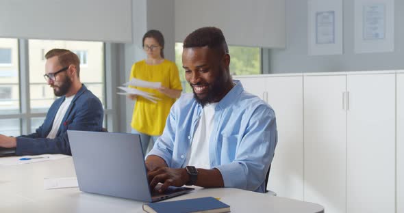 African American Businessman Working on Laptop in Coworking Space alt