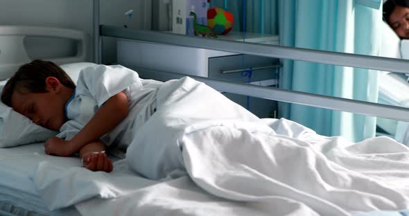 Patients resting with teddy bear on bed alt