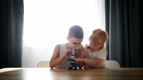 Child Baby Caucasian Little Boy Scientist Biologist Researcher Working with Microscope and Show It