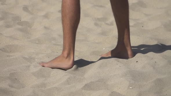 Detail of a mans feet while playing pro beach volleyball. alt