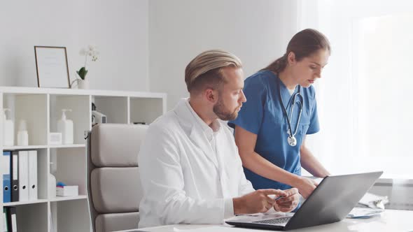 Professional medical doctors working in hospital office. Physician and the young nurse. alt