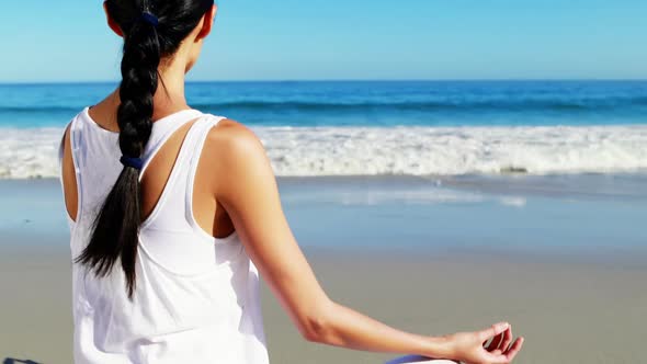 Rear view of woman performing yoga alt