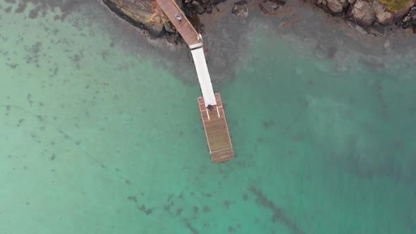 Pontoon filmed from above on a coastal scenary