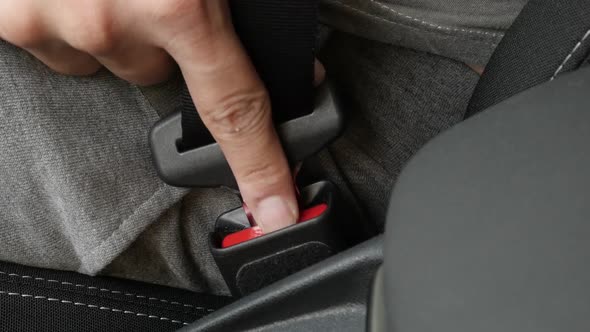 Unbuckling 3-point seat  belt slow-mo video