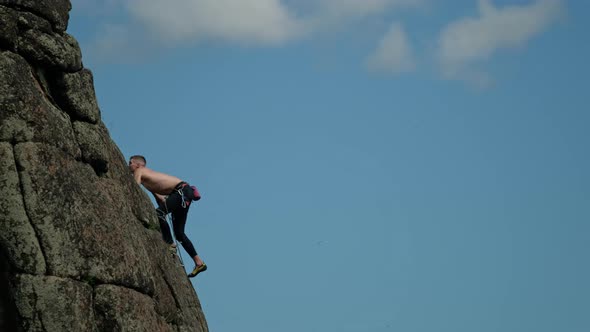 A Man Climbs a Rocky Ridge