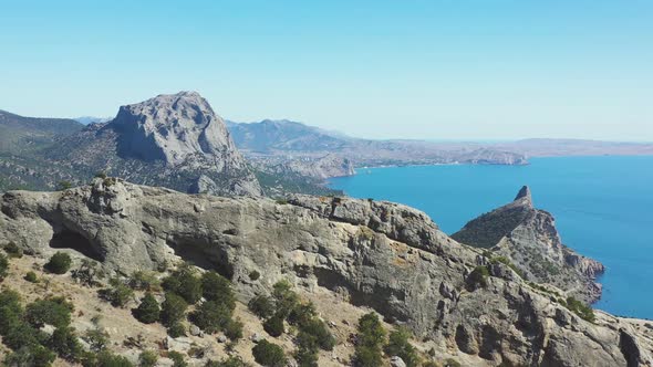 Drone Flight Above the Crest of the Stone Reef Beyond Which the Valley and City Views alt