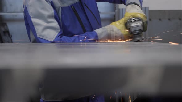 Iron worker industrial grinder steel construction metal grinding sparks. Metal worker grinder