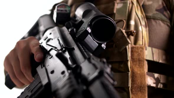 Combat rifle with telescopic sight and tactical armor in the hands of a special forces soldier