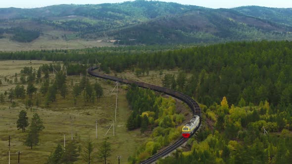 A Freight Train Is Carrying Coal Through the Forests alt