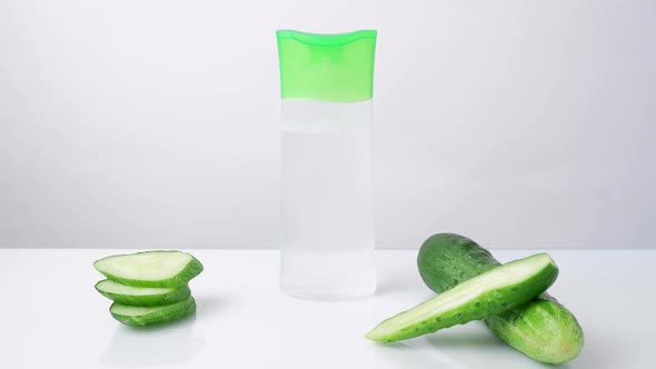a Woman's Hand Puts Takes From the Table on Which Lies a Cucumber a Tube with a Refreshing Cucumber