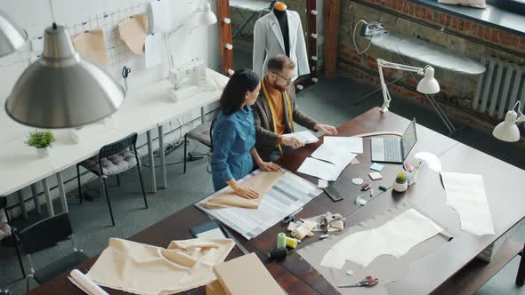 Top View of Colleagues Dressmakers Talking Working in Studio Together alt
