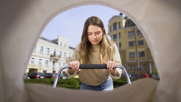 Exhausted Young Mother Falling Asleep Swinging Pram, Lack of Energy, Infant Pov alt