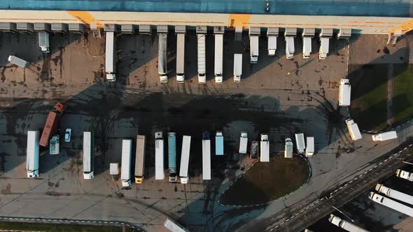 Flycam Films Big Trucks Standing in Row at Loading Gates alt