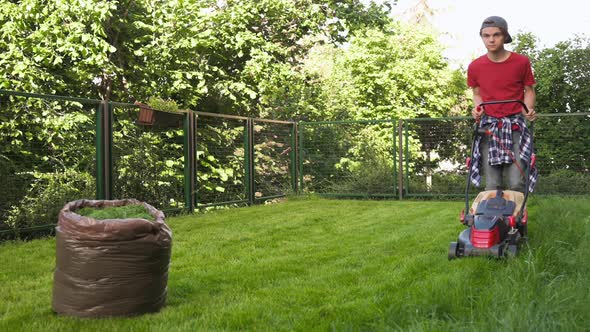 Boy Cutting Grass with Lawn Mower alt