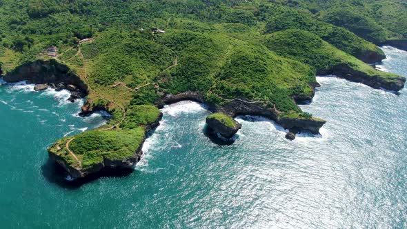 Tropical green promontory shoreline aerial view, Kesirat, Yogyakarta, Indonesia alt