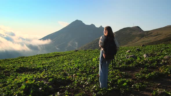 Explore Nature at Summer Vacation Young Female Backpacker is Strolling at Top of Mountain alt