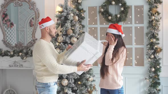 Attractive Girl Receives a Gift on Christmas