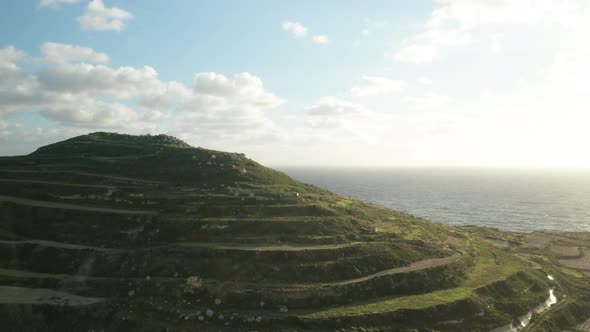 AERIAL: Hill with Paddy Fields with View to Mediterranean Sea During Winter in Malta