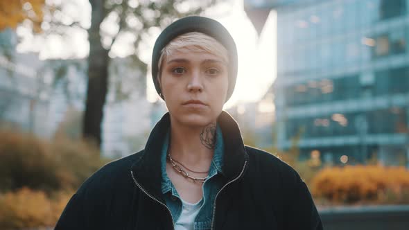 Portrait of Blond Woman with Winter Hat and Jacket Looking Angy at the Camera alt