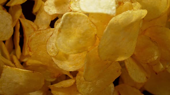 Super Slow Motion Shot of Potato Chips Flies After Being Exploded Against Black Background 1000Fps alt
