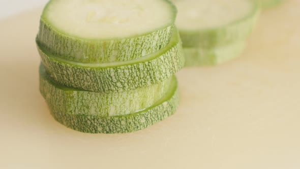 Sliced Pepo cylindrica on cutting board close-up 4K 2160p 30fps UltraHD tilting  footage - Slices of alt