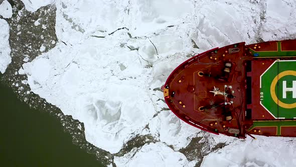 Aerial Epic Red Ship in Winter Sails Through Frozen Sea Makes Its Way. Ice Floe Graphic Pattern alt
