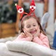 Playful Smiling Cute Girl Wearing Funny Festive Ears Rejoicing Holiday Looking at Camera - VideoHive Item for Sale