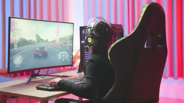 Excited Girl Playing Car Race Game On A Computer alt