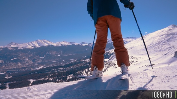Skier Going Over Edge and Starts Skiing From a Mountain Top With Picturesque Views alt