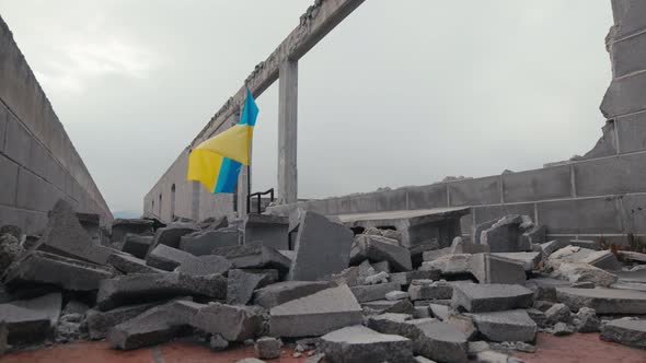 Waving Ukraine Flag on the Building Destroyed in War By Russia alt