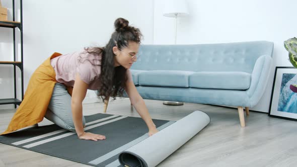Slow Motion of Homeowner Rolling Soft Carpet in Front of Sofa Then Cleaning It with Brush alt