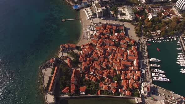 Red Roofs of Old Houses in Budva Against the Background of the Pier alt