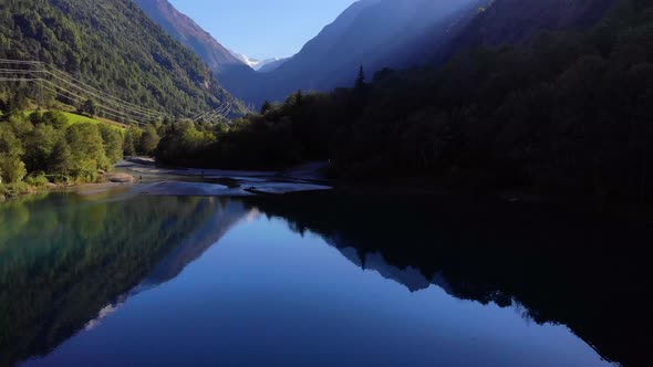 Calm Waterscape Of Klammsee Lake With A View Of Austrian Alps In Kaprun, Austria. aerial alt