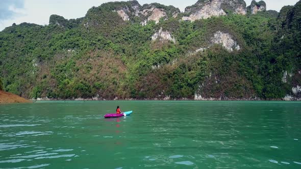 Cute Asian Girl Chilling Kayaking in Cheow Lan Lake Thailand