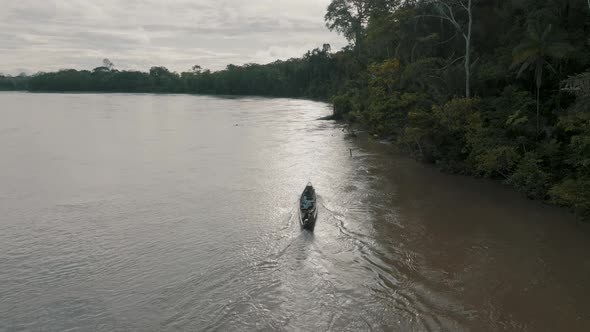 Aerial shot of boat sailing in the river. Small boat with local people on the Javari River, Amazon b alt
