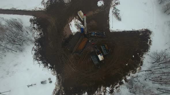 Drilling a Deep Well with a Drilling Rig in an Oil and Gas Field in Winter Forest. Field Is Located