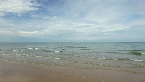 Aerial view of small fishing boat navigating on calm water, Ko Chang, Thailand. alt
