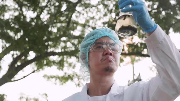 Scientist team in protective suits and masks took a sample of water for analysis
