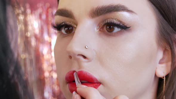 Bright Lip Makeup Big Beautiful Lips are Painted with Red Lipstick with a Special Brush in a Beauty alt