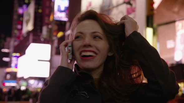 Woman talking on cell phone in Times Square, New York City