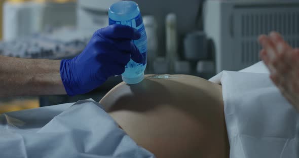 Doctor Examining a Pregnant Woman with Ultrasound alt