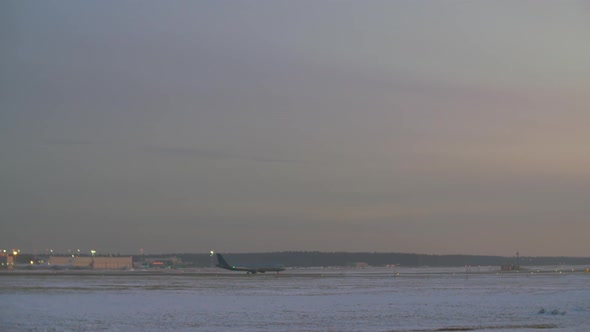 Airplane Taking Off. Airport View in Winter Evening alt