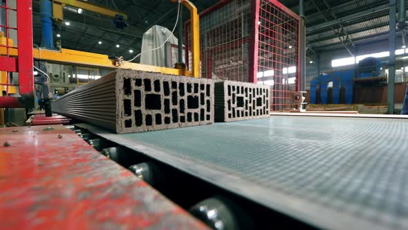 Brick Units are Moving Along the Belt While Getting Cut alt